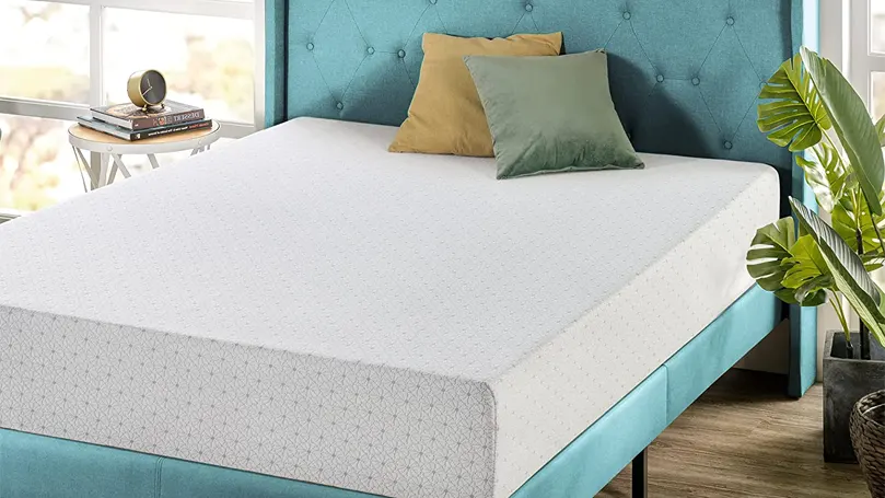 Image d'un matelas à mémoire de forme sur un lit bleu.