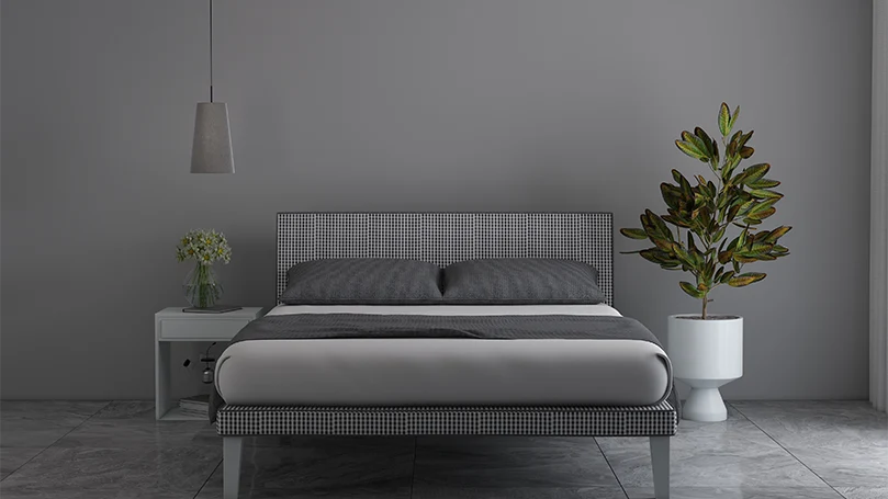 Image d'un cadre de lit simple dans une chambre grise